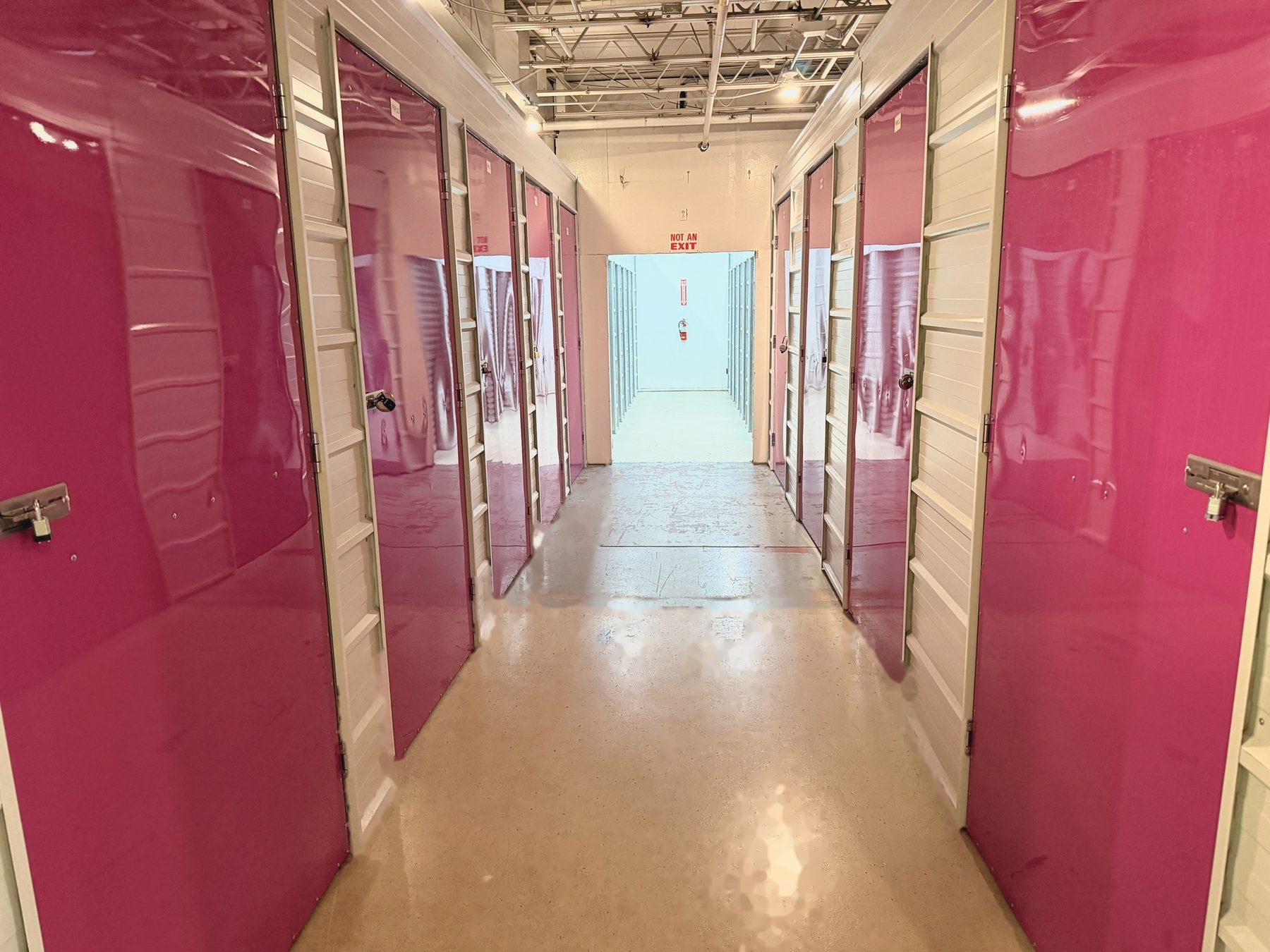 Pink-door hallway inside Storio Anchorage